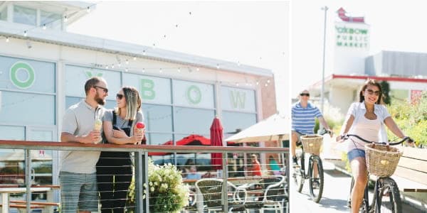 A couple holding ice cream cones smiles at each other while standing on a restaurant patio. Another couple rides cruiser bikes in front of a sign for Oxbow Public Market.
