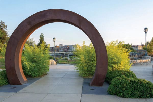 A circular Moon Gate structure frames a view of the Napa Riverfront