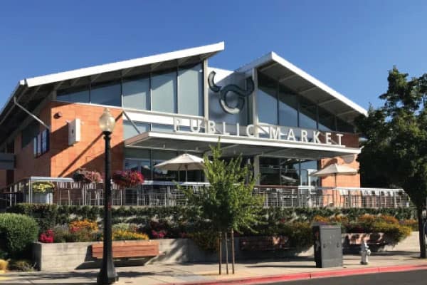Exterior of the Oxbow Public Market building with patio seating